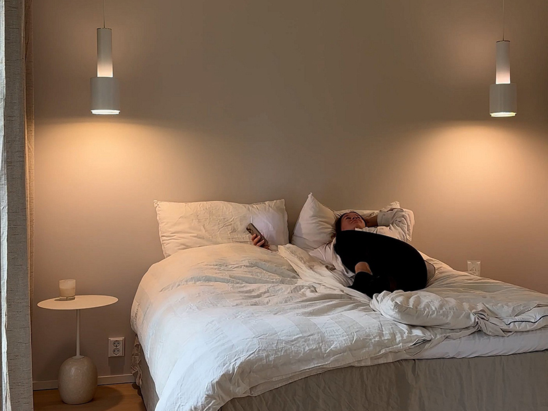 Atmospheric bedroom lighting with a woman lying on the bed